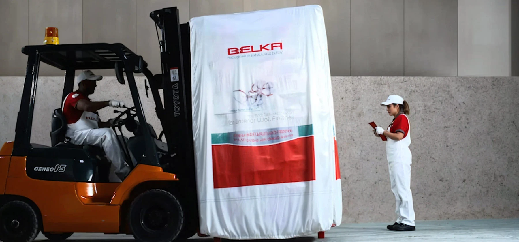 Workers preparing a large pallet of Belka Wallpaper materials for transport.